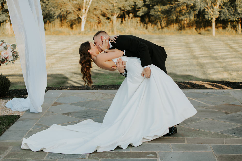 Capturing the magic with an aisle dip kiss at Zion Springs, a premier wedding location.