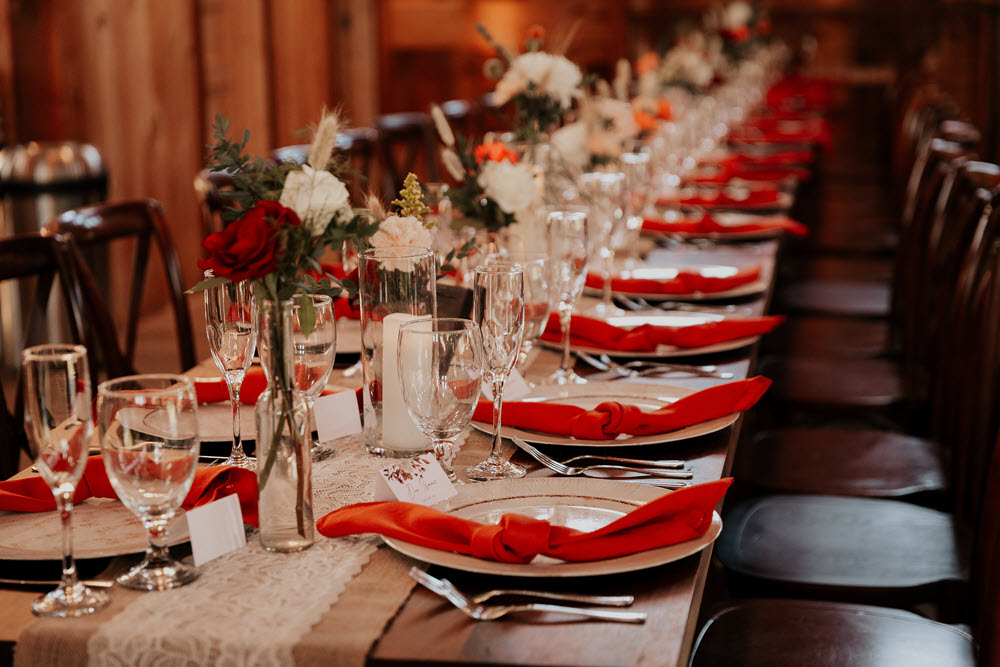 Rustic-themed wedding table setting at Zion Springs's barn wedding venue in Loudoun County.