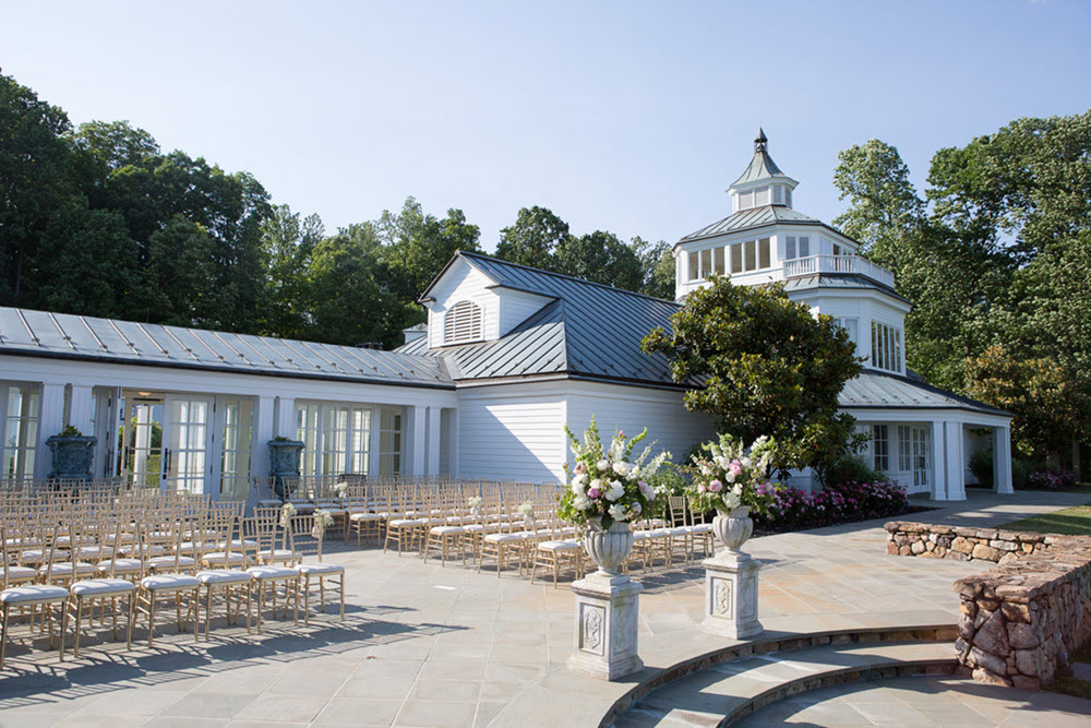 Elegant outdoor wedding setup at Trump Winery with panoramic views of Charlottesville's landscape.